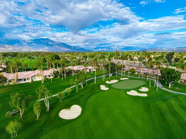 a view of a golf course with chairs