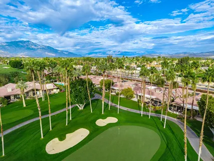 a view of a golf course with chairs