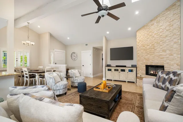 a living room with fireplace furniture and a flat screen tv