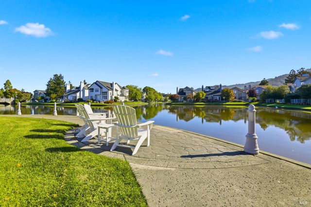 a front view of a house with a yard and fountain