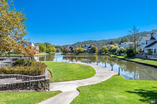 a view of a lake with a house in the background