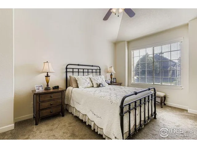 a bedroom with a bed a window and walk in closet