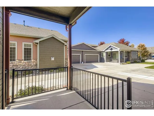 a view of a house with a wooden fence