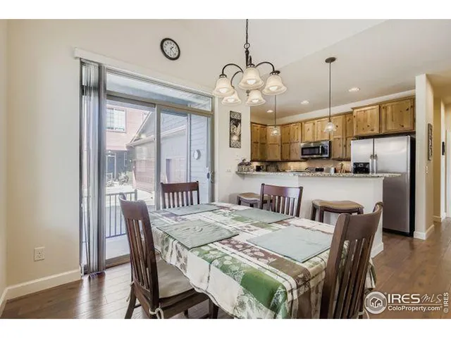 a view of a dining room with furniture large window and chandelier