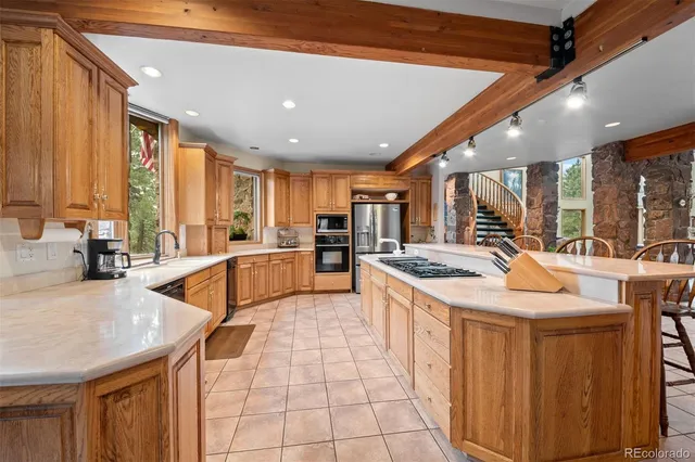 a kitchen with stainless steel appliances granite countertop a sink and a counter