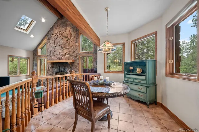 a living room with furniture a fireplace and a chandelier