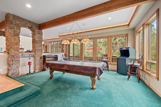 a room with pool table and windows