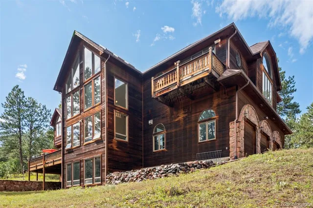 a front view of a residential apartment building with a yard