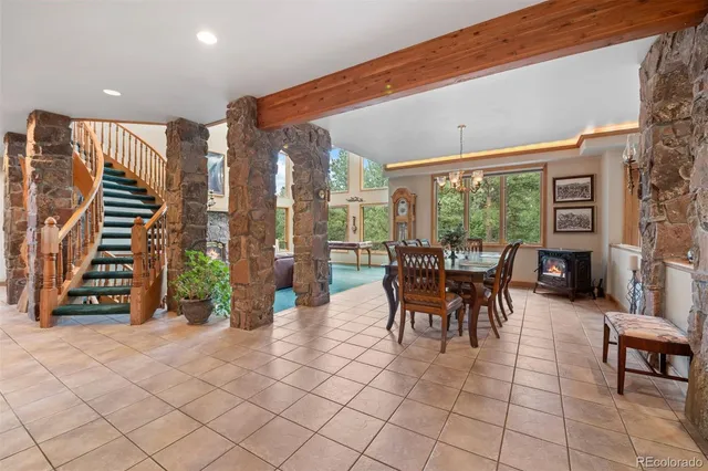 a dining room with furniture and a floor to ceiling window