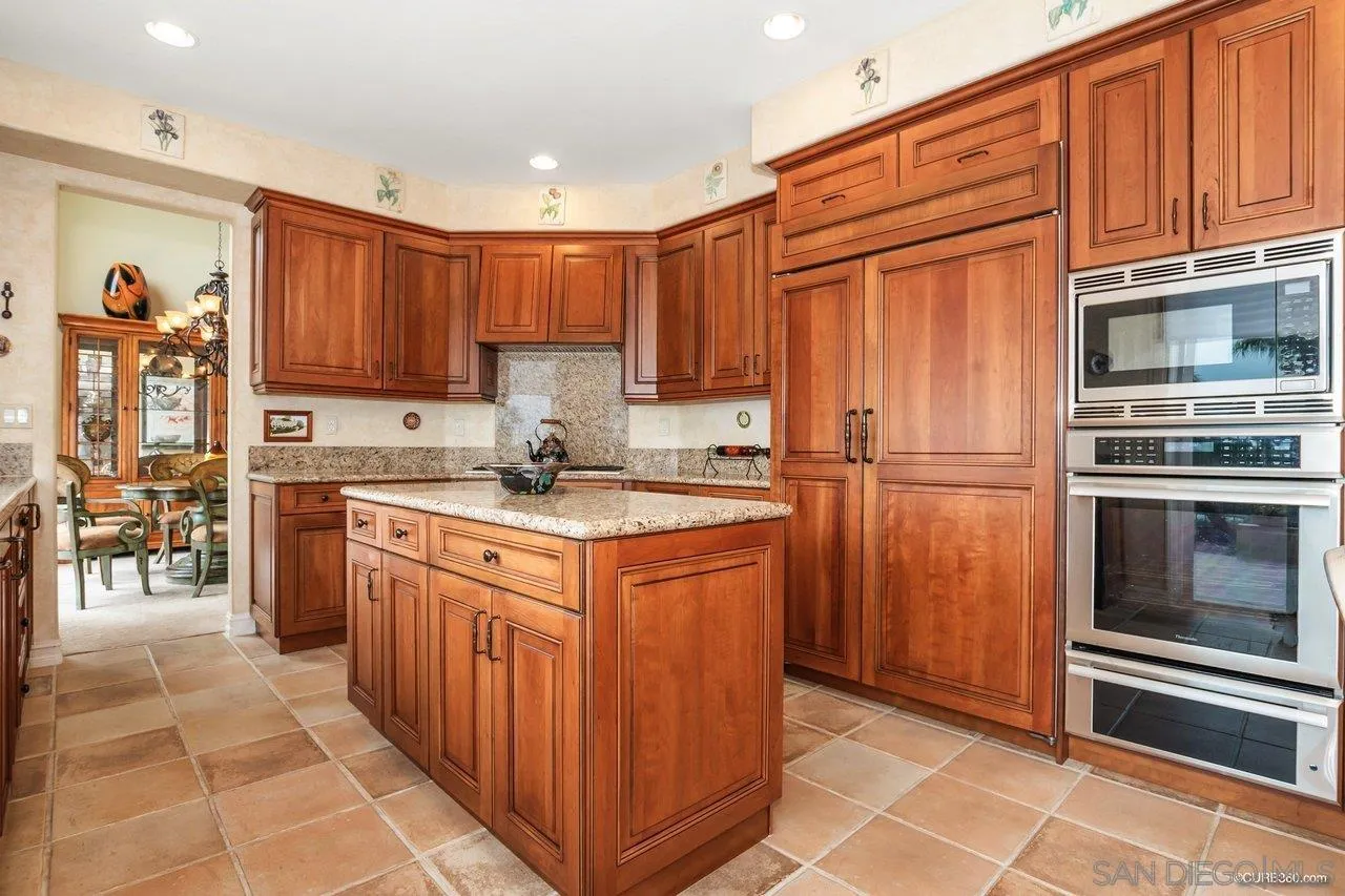 2451 Selkirk Row La Jolla, CA 92037 - Photo 12 of 37 a kitchen with stainless steel appliances granite countertop a refrigerator and a stove top oven