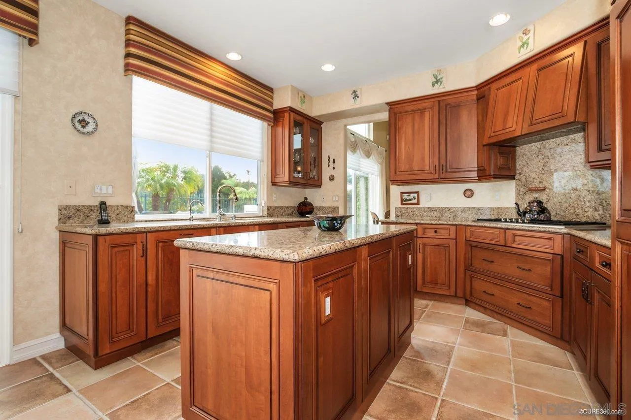 2451 Selkirk Row La Jolla, CA 92037 - Photo 13 of 37 a kitchen with stainless steel appliances granite countertop a sink a stove and a refrigerator