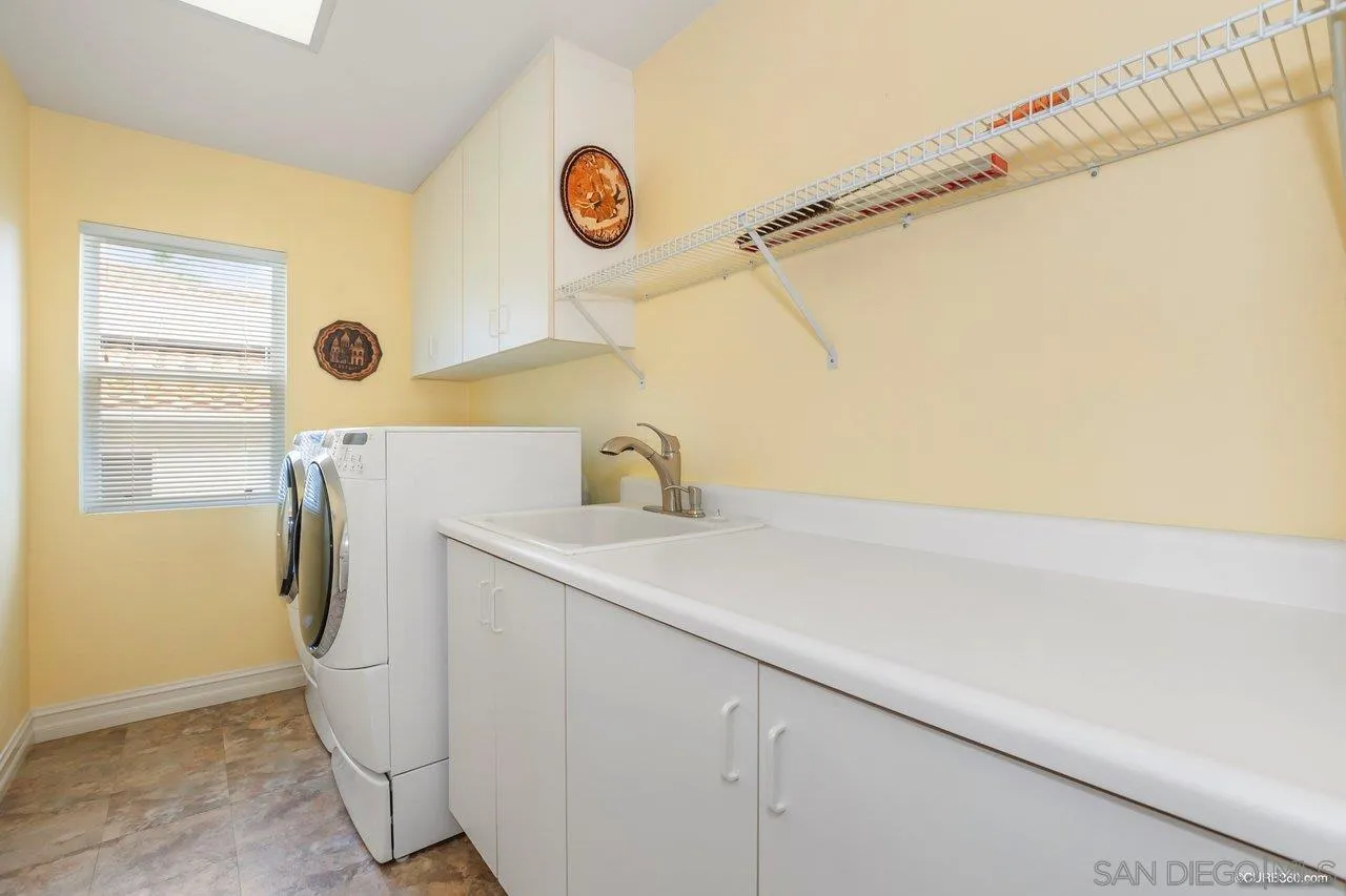 2451 Selkirk Row La Jolla, CA 92037 - Photo 23 of 37 a utility room with a window dryer and washer