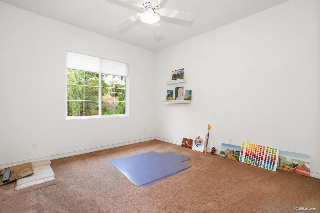 2451 Selkirk Row La Jolla, CA 92037 - Photo 24 of 37 a bedroom with a bed and a chandelier