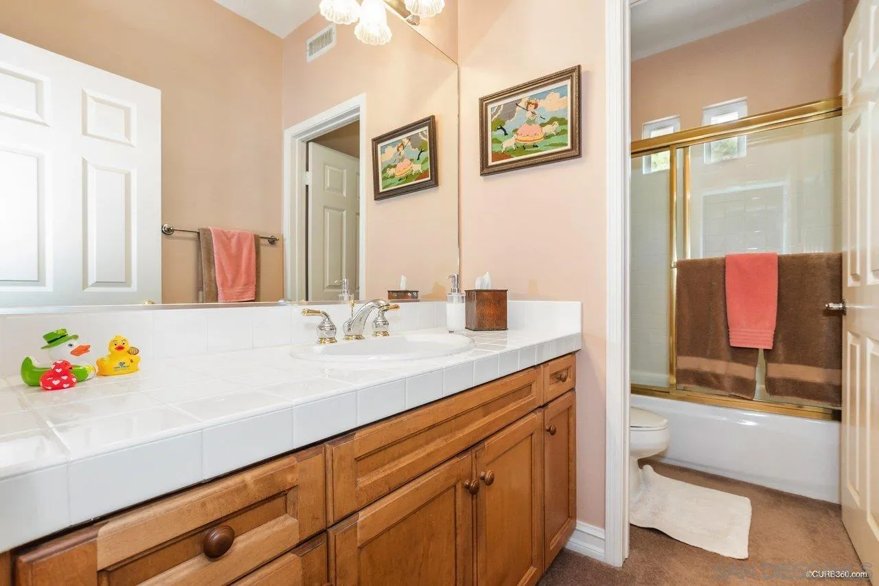 2451 Selkirk Row La Jolla, CA 92037 - Photo 26 of 37 a bathroom with a sink and a mirror