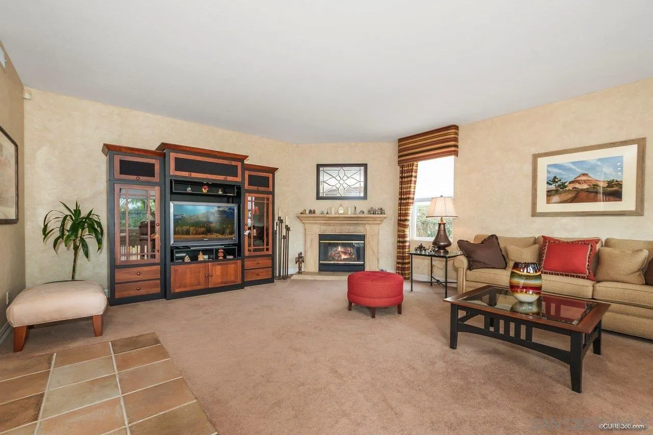 2451 Selkirk Row La Jolla, CA 92037 - Photo 9 of 37 a living room with furniture a flat screen tv and a large window