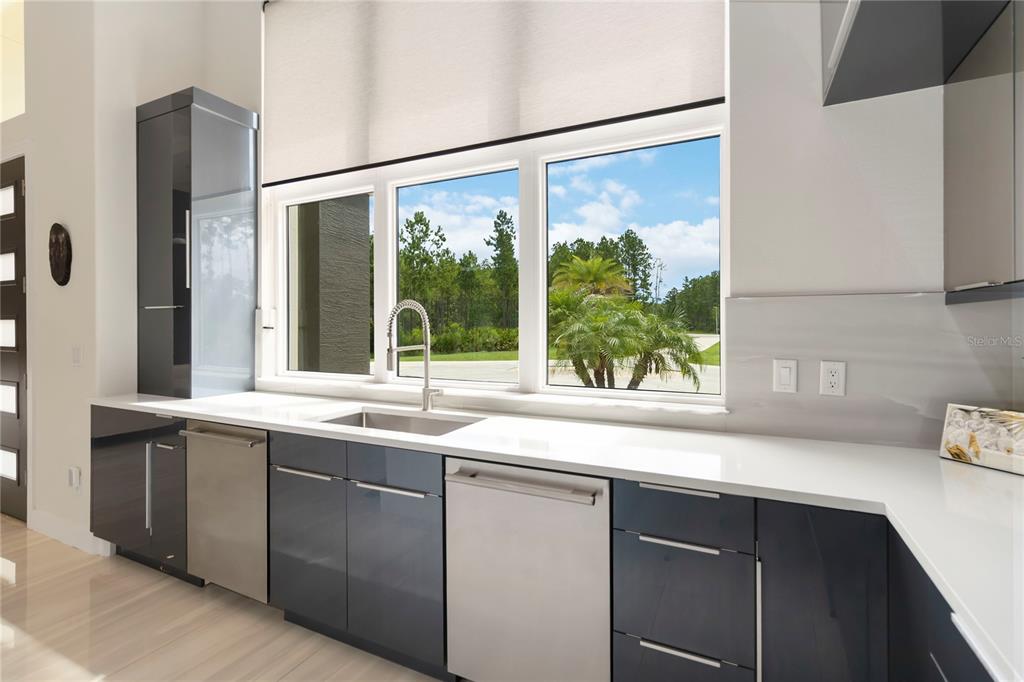 113 Spring Rise Circle Bunnell, FL 32110 - Photo 14 of 45 a sink with a large window and cabinets