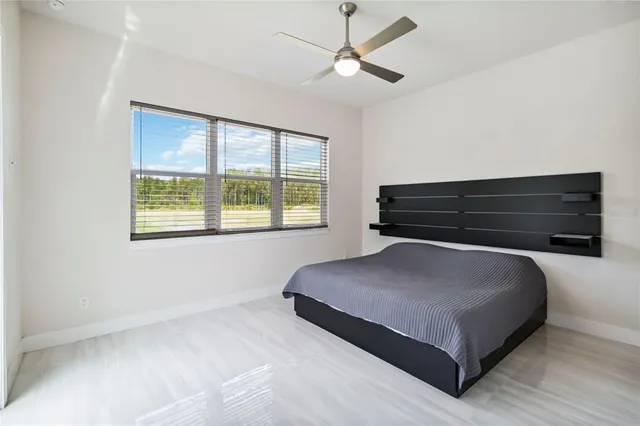 a bedroom with a bed and window
