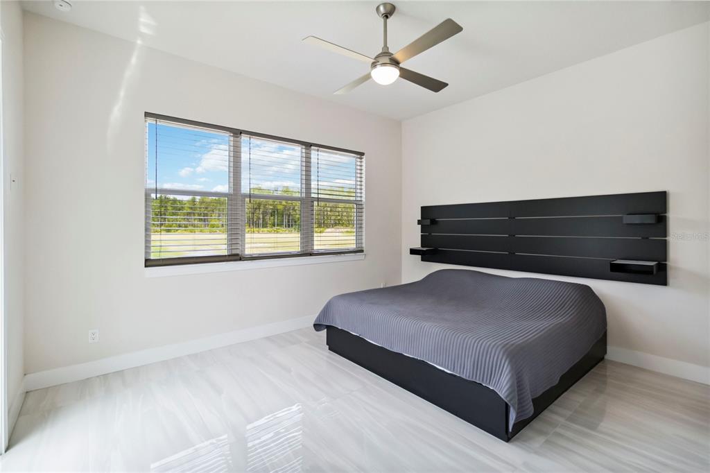 113 Spring Rise Circle Bunnell, FL 32110 - Photo 16 of 45 a bedroom with a bed and window