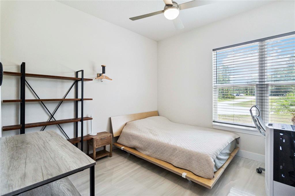 113 Spring Rise Circle Bunnell, FL 32110 - Photo 22 of 45 a bedroom with a bed next to a window