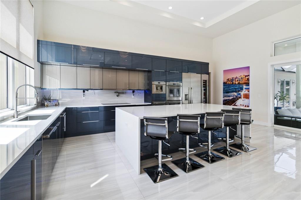 113 Spring Rise Circle Bunnell, FL 32110 - Photo 9 of 45 a kitchen with stainless steel appliances kitchen island granite countertop a table chairs sink and cabinets