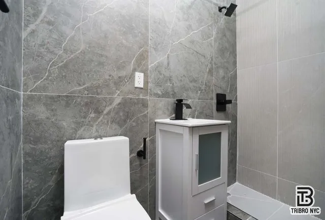 a bathroom with a toilet sink and shower