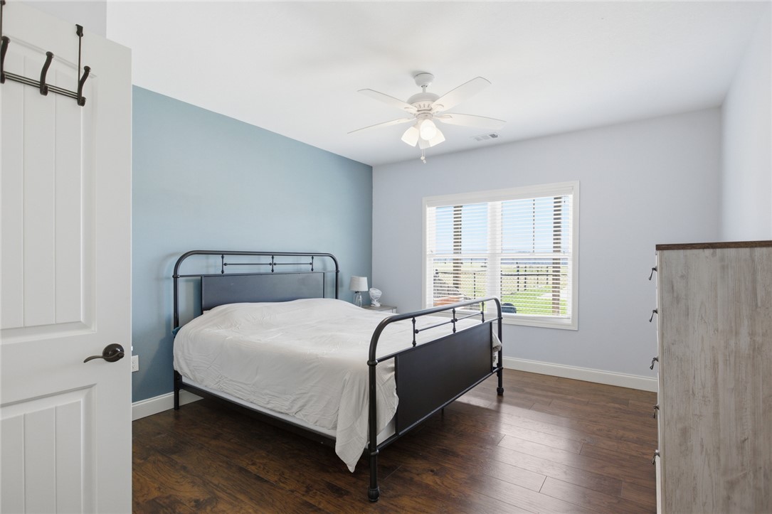426 Oak Creek Road Seneca, SC 29678 - Photo 28 of 50 This tranquil bedroom features rich hardwood flooring and abundant natural light, offering a serene personal retreat.