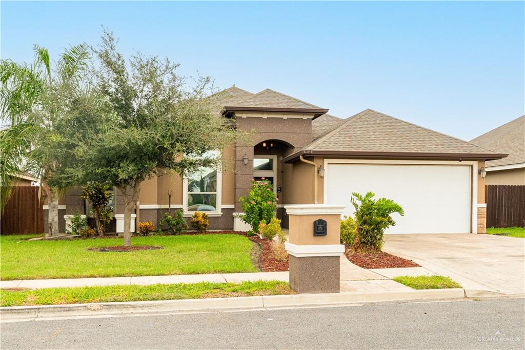 3902 Sherman Street Edinburg, TX 78542 - Photo 2 of 20 a front view of a house with garden