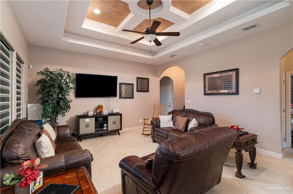 3902 Sherman Street Edinburg, TX 78542 - Photo 4 of 20 a living room with furniture a flat screen tv and a wall painting