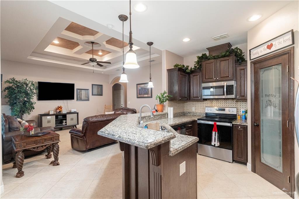 3902 Sherman Street Edinburg, TX 78542 - Photo 6 of 20 a kitchen that has a sink cabinets and stainless steel appliances