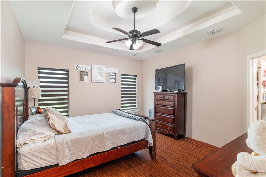 3902 Sherman Street Edinburg, TX 78542 - Photo 9 of 20 a bedroom with a bed and wooden floor