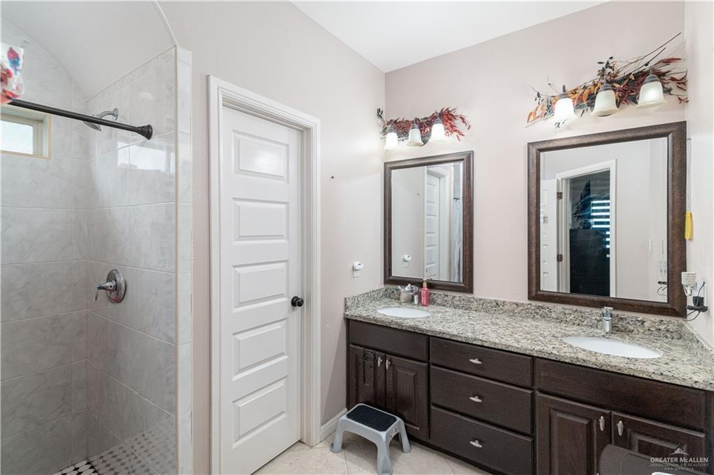 3902 Sherman Street Edinburg, TX 78542 - Photo 10 of 20 a bathroom with a granite countertop sink mirror and a