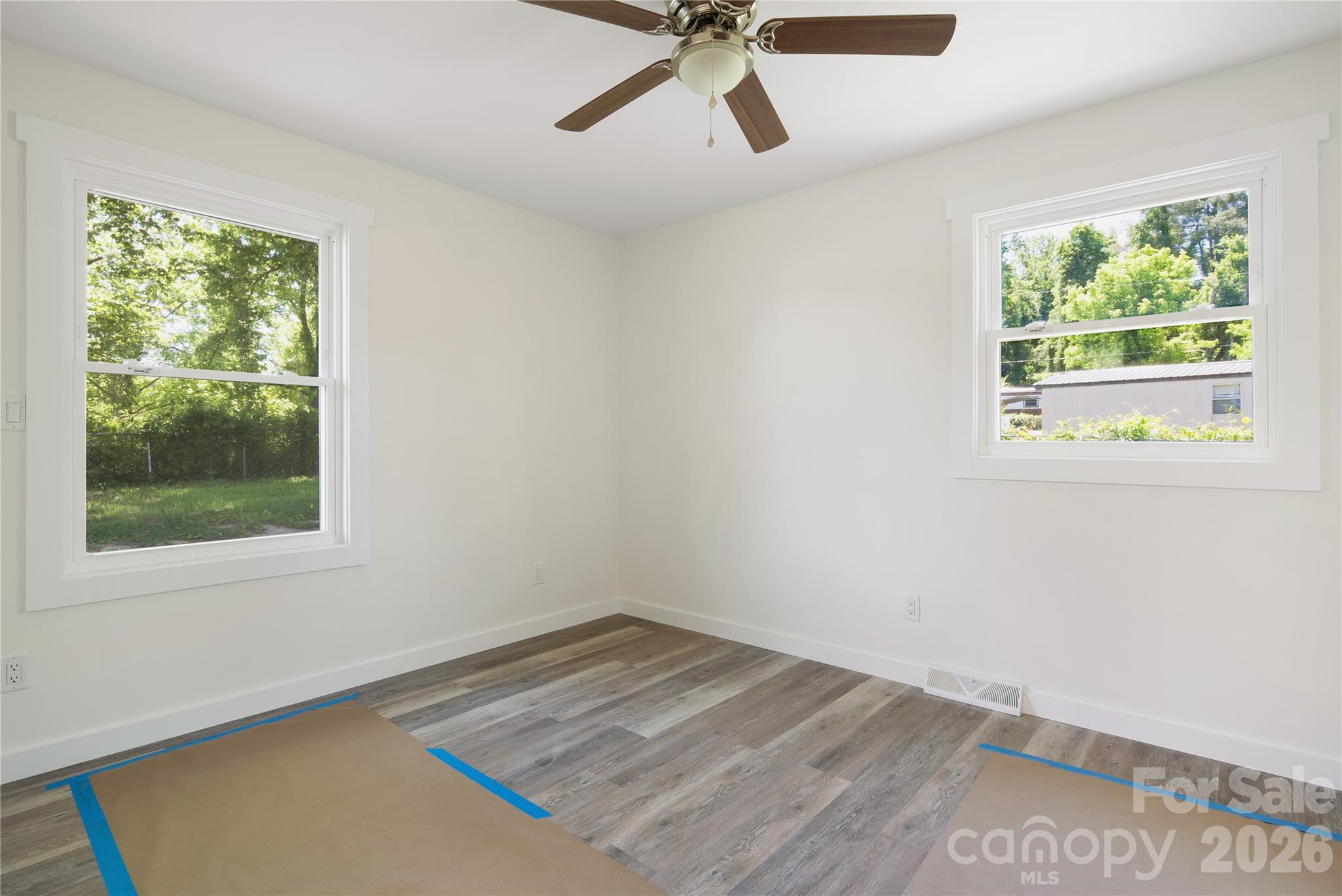 287 Duncan Road Flat Rock, NC 28731 - Photo 11 of 13 a view of empty room with wooden floor and fan
