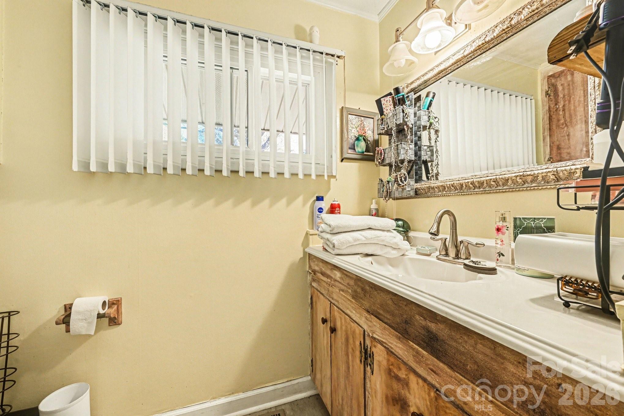 1107 Crestfield Drive Lancaster, SC 29720 - Photo 14 of 29 a bathroom with a granite countertop sink and a mirror