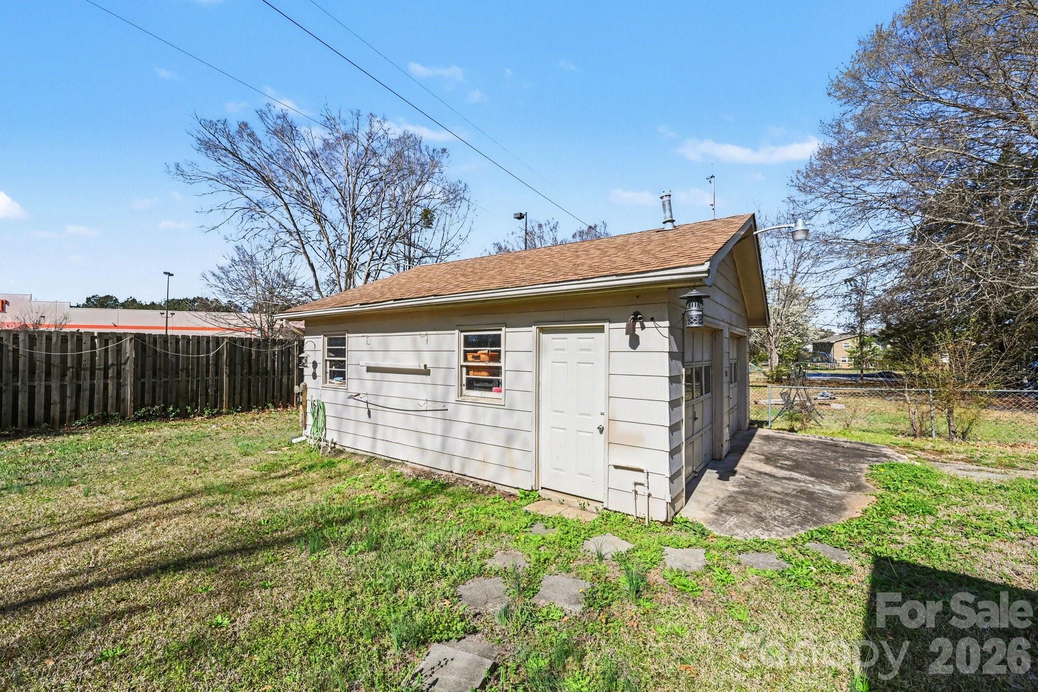 1107 Crestfield Drive Lancaster, SC 29720 - Photo 27 of 29 a backyard of a house with large trees and wooden fence
