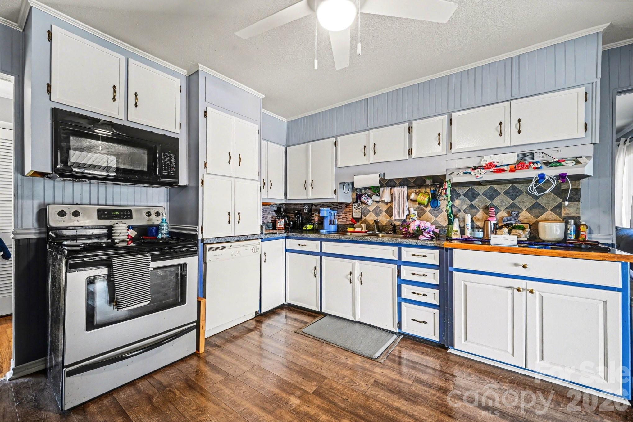 1107 Crestfield Drive Lancaster, SC 29720 - Photo 8 of 29 a kitchen with stainless steel appliances granite countertop a stove a sink and a microwave