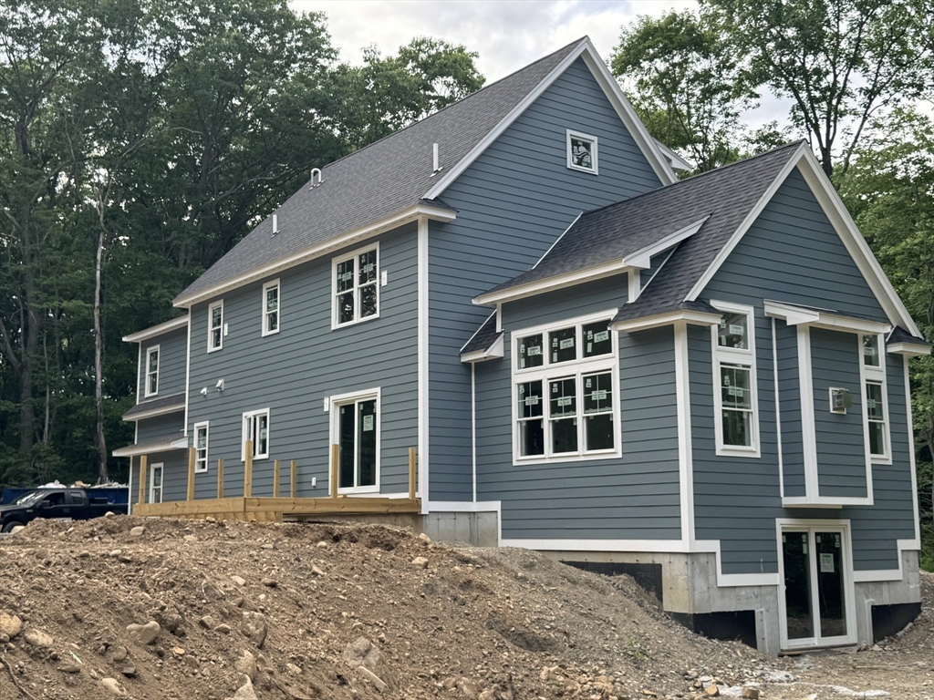 104 King George Drive Boxford, MA 01921 - Photo 5 of 19 a front view of a house with a garden