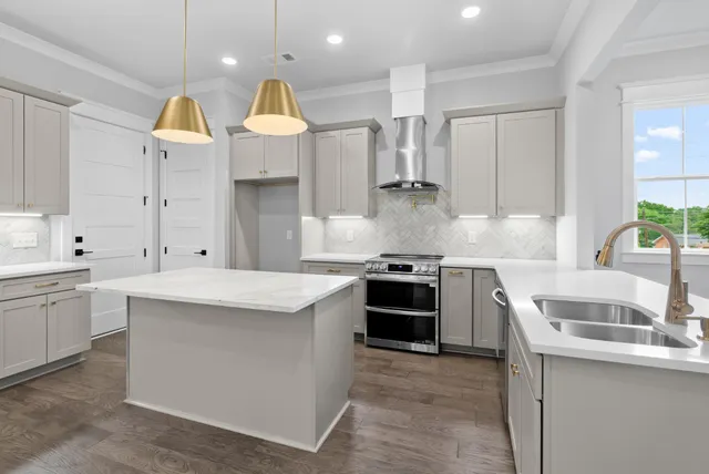 a kitchen with a sink stove and refrigerator