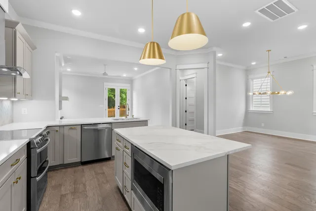 a stove top oven sitting inside of a kitchen