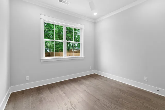 an empty room with wooden floor