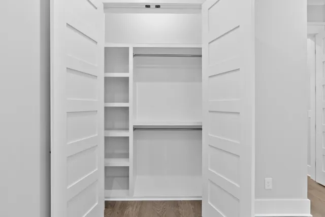 a very nice looking room with wooden floor and stairs