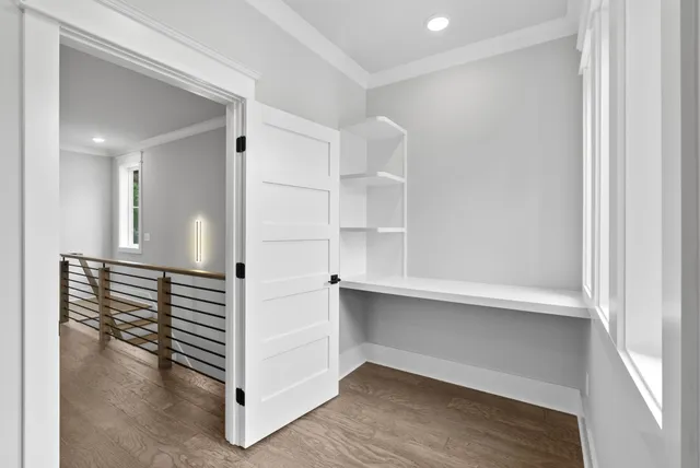 a view of a hallway with wooden floor