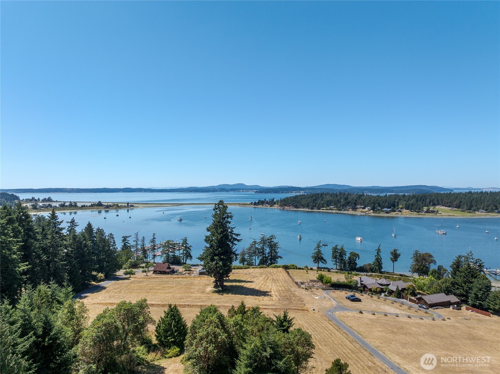 295 Rum Runner Road Lopez Island, WA 98261 - Photo 17 of 37 a view of a lake with beach and city view