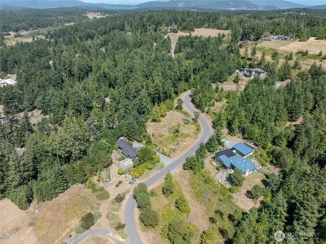 an aerial view of a house with a yard