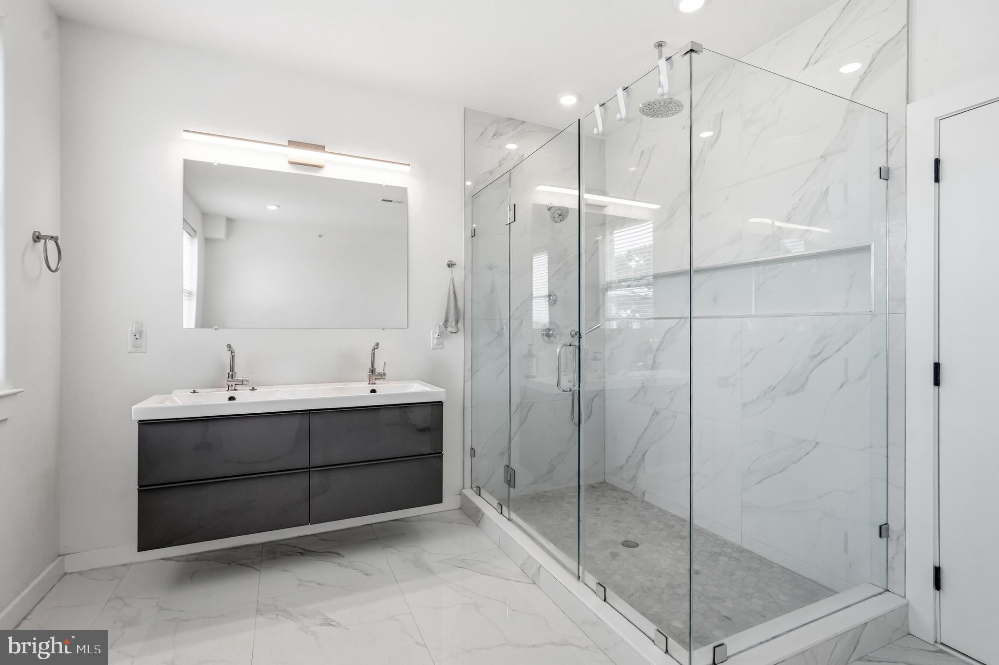 2604 Reed Street Philadelphia, PA 19146 - Photo 18 of 45 a bathroom with a shower sink and mirror