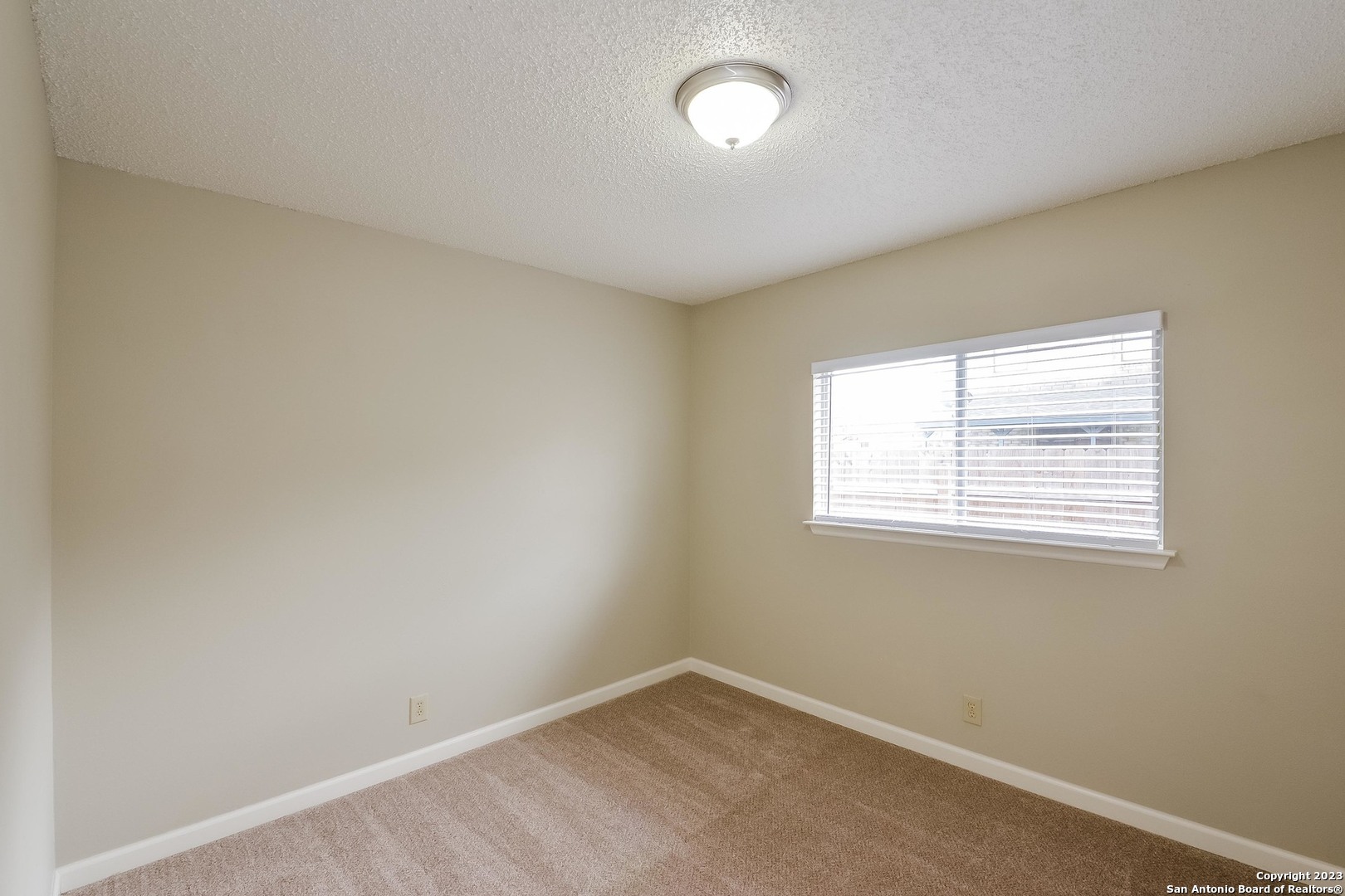 8007 Manderly Place Converse, TX 78109 - Photo 11 of 15 an empty room with a window
