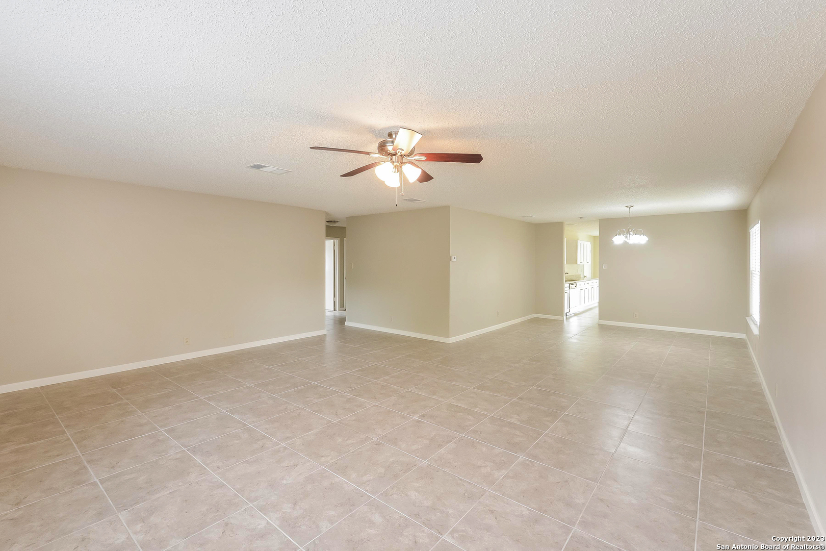 8007 Manderly Place Converse, TX 78109 - Photo 3 of 15 a view of an empty room with a ceiling fan