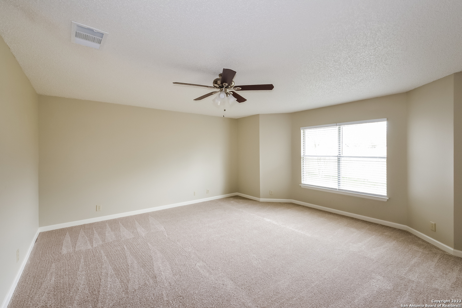 8007 Manderly Place Converse, TX 78109 - Photo 8 of 15 wooden floor in an empty room with a window