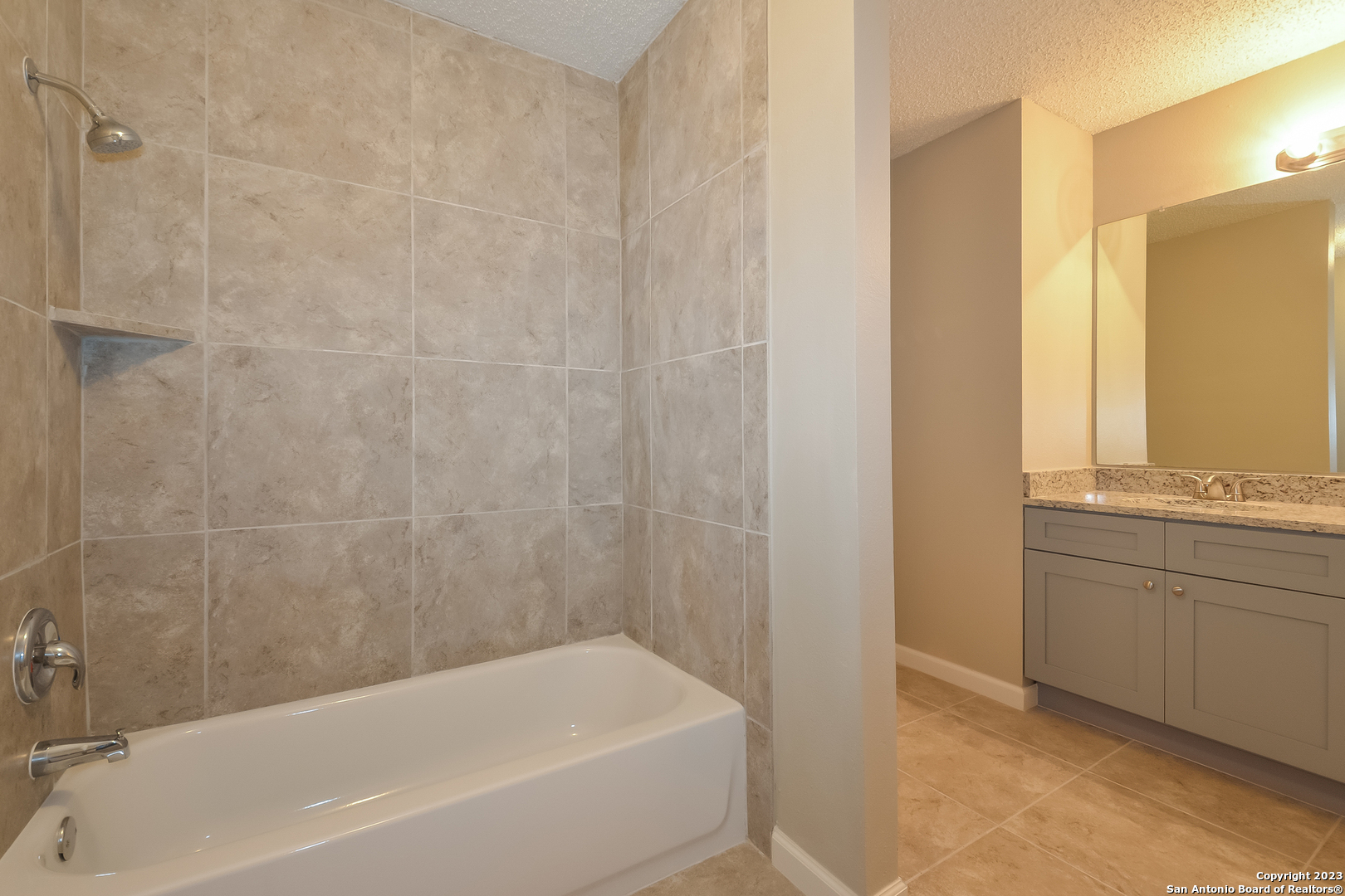 8007 Manderly Place Converse, TX 78109 - Photo 10 of 15 a bathroom with a bathtub and a sink