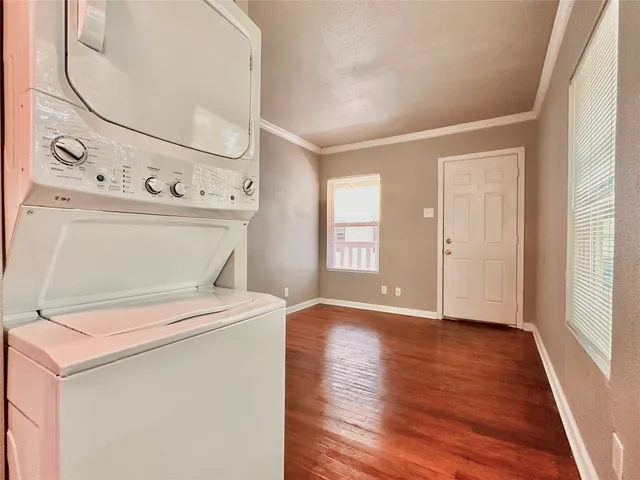 a view of washer and dryer with wooden floor
