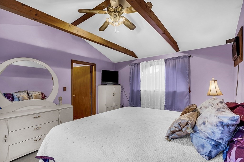 271 Broadway Haverhill, MA 01832 - Photo 19 of 26 a bedroom with a bed and a chandelier